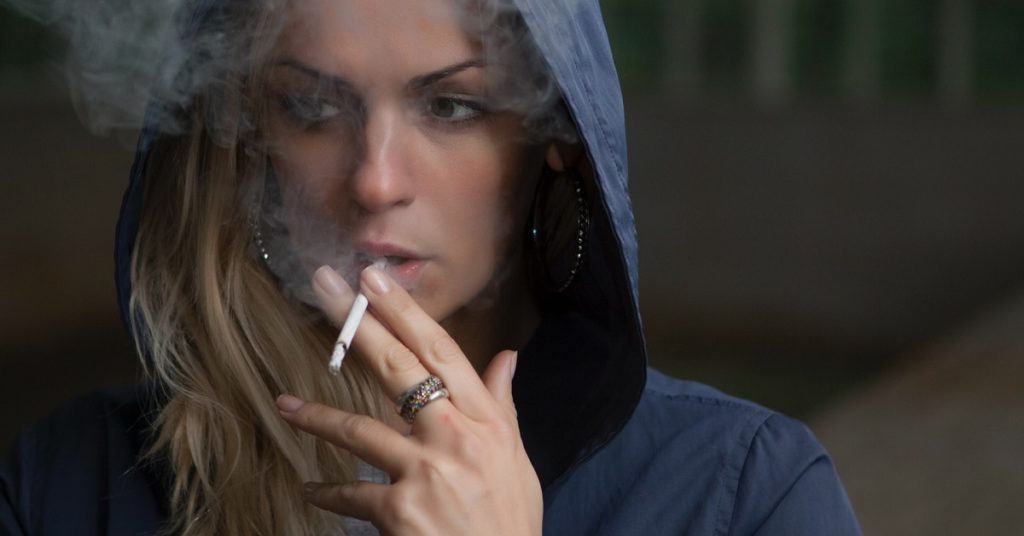 A woman smoking while thinking of a quit smoking timeline in Birmingham